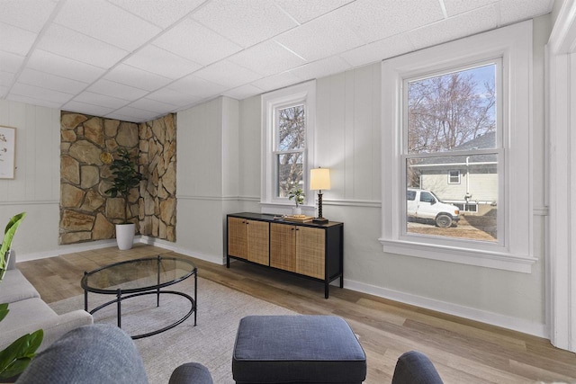 living area featuring baseboards and wood finished floors