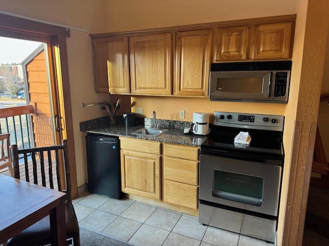 kitchen with light tile patterned flooring, appliances with stainless steel finishes, and a sink