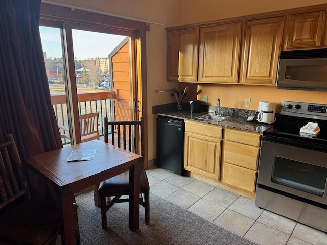 kitchen with light tile patterned flooring, appliances with stainless steel finishes, and a sink