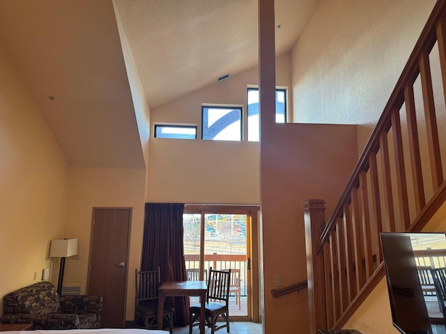 stairway featuring high vaulted ceiling