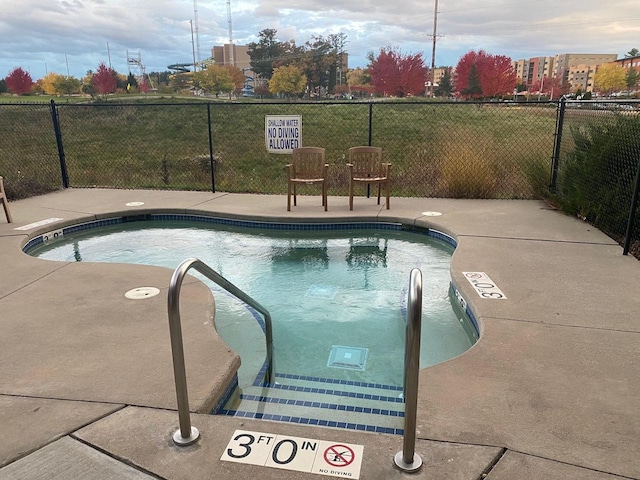 view of pool with a swimming pool and fence