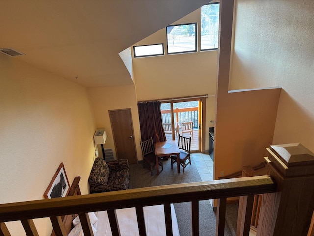 stairs featuring visible vents and a high ceiling