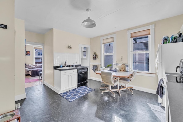 kitchen with a sink, dark countertops, range with electric stovetop, baseboards, and dishwasher