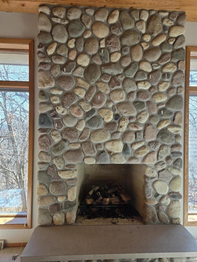 room details with a stone fireplace and visible vents