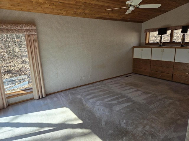 unfurnished bedroom with ceiling fan, wood ceiling, carpet, and vaulted ceiling