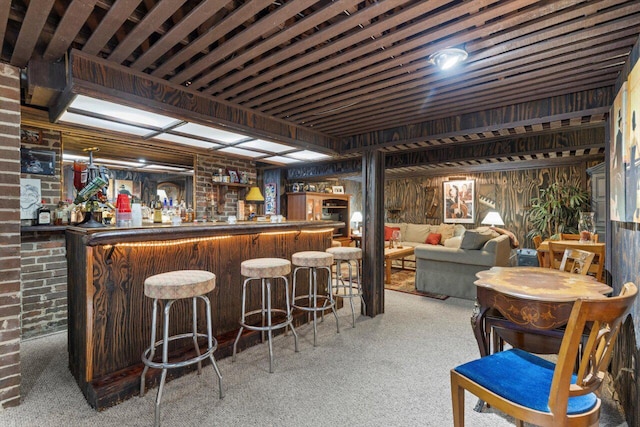 bar featuring a dry bar, carpet, and brick wall