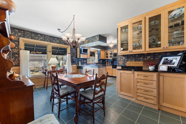 dining area with wallpapered walls, dark tile patterned floors, and a chandelier