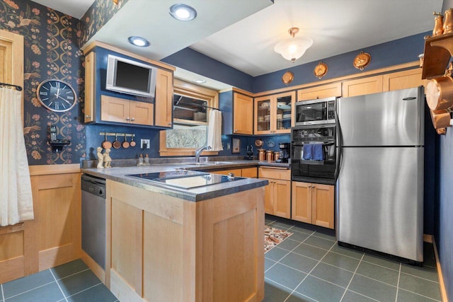 kitchen featuring wallpapered walls, black appliances, a peninsula, and light brown cabinetry