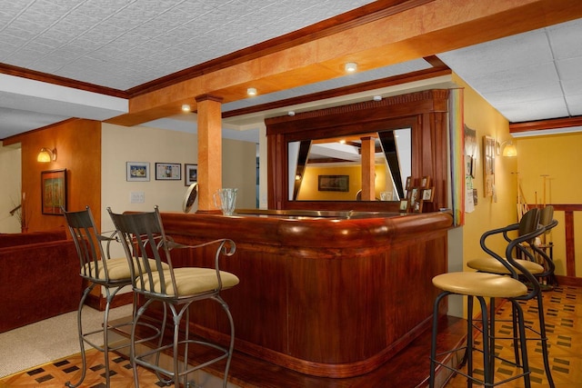 bar featuring indoor bar and ornamental molding