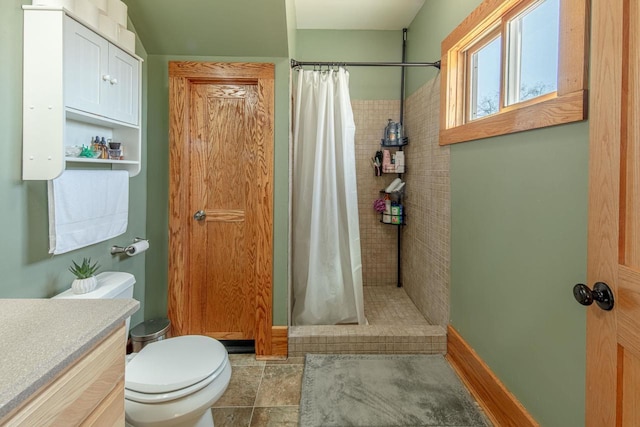 bathroom with vanity, a shower stall, and toilet