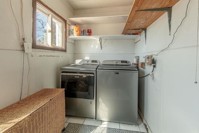 clothes washing area with washer and clothes dryer and laundry area