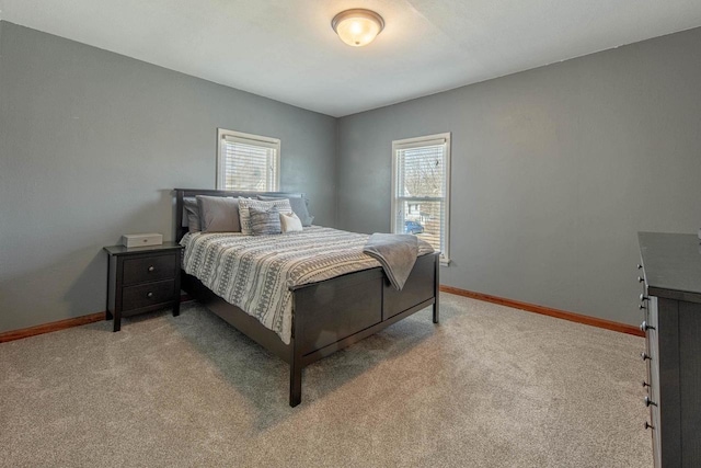 bedroom with baseboards and light carpet