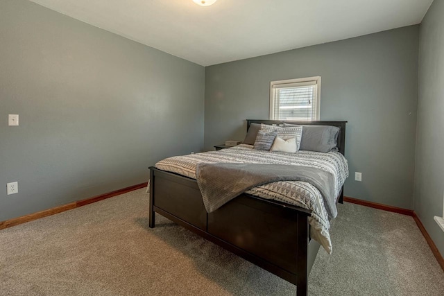 bedroom featuring carpet and baseboards