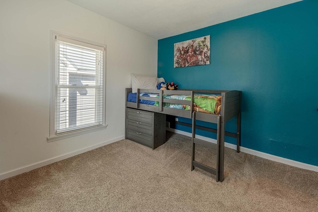 bedroom featuring carpet flooring and baseboards