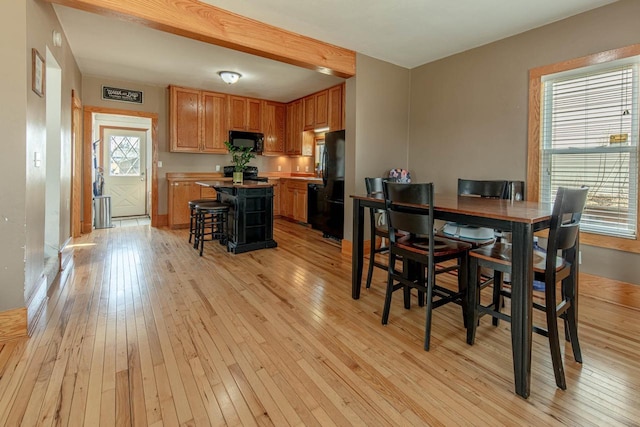 dining area featuring light wood-style flooring