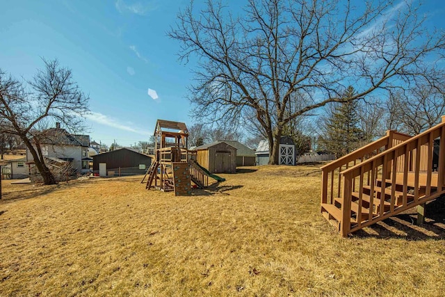 view of yard with an outbuilding, a storage shed, and a playground