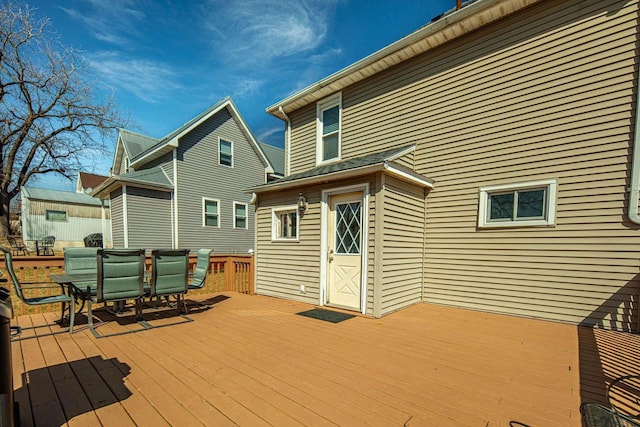 wooden terrace with outdoor dining area