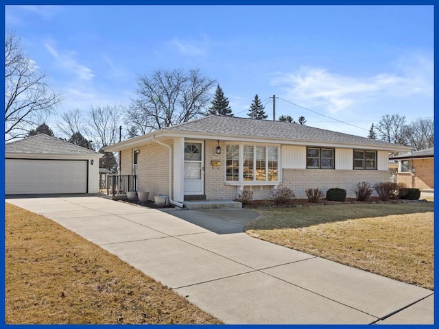 ranch-style house featuring a shingled roof, an outbuilding, brick siding, and a front lawn