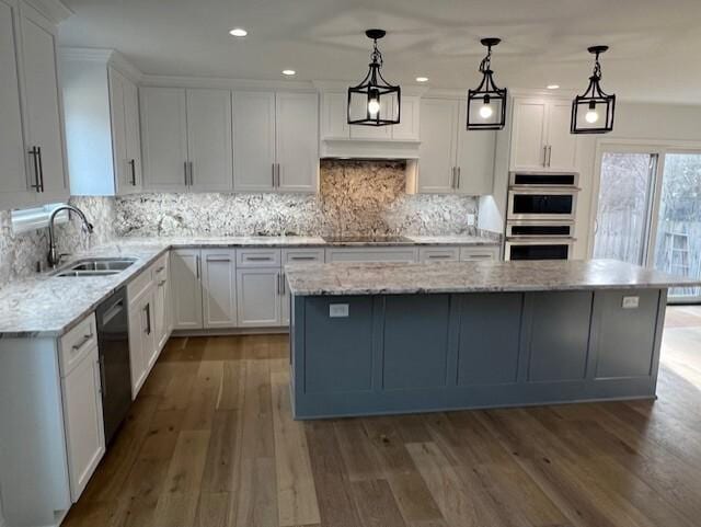 kitchen featuring a sink, double oven, white cabinets, and black dishwasher