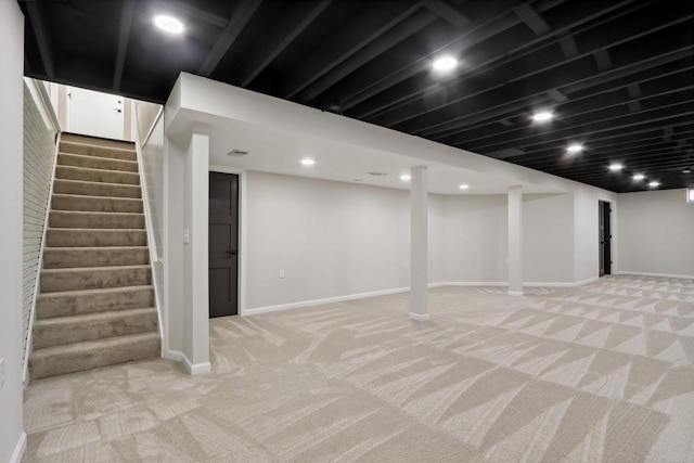 finished basement featuring recessed lighting, stairway, light colored carpet, and baseboards