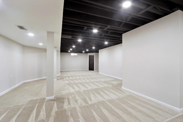 finished basement with recessed lighting, visible vents, baseboards, and light carpet