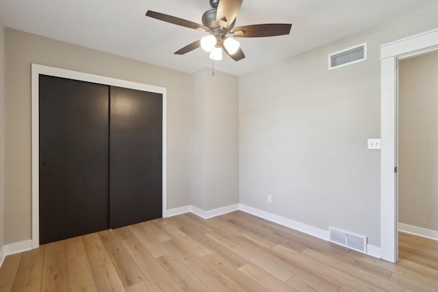 unfurnished bedroom with baseboards, visible vents, and light wood finished floors