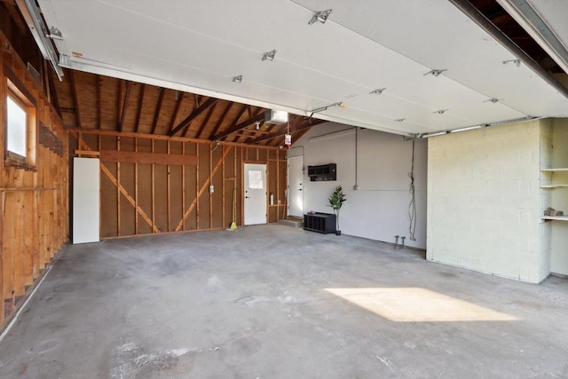 garage featuring wooden walls and a garage door opener