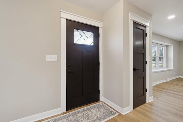 foyer with light wood finished floors, recessed lighting, and baseboards