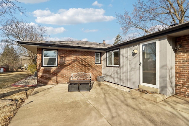 exterior space with a patio and brick siding