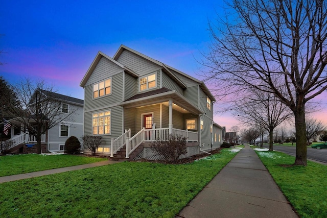 view of front of house featuring a front lawn and covered porch