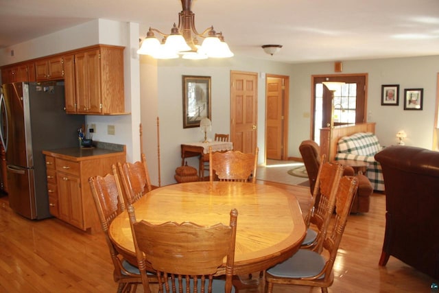 dining area with a chandelier and light wood finished floors