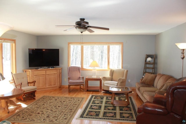 living room featuring ceiling fan and light wood finished floors