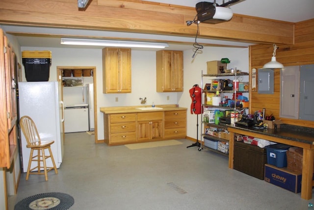 interior space with electric panel, concrete floors, and freestanding refrigerator