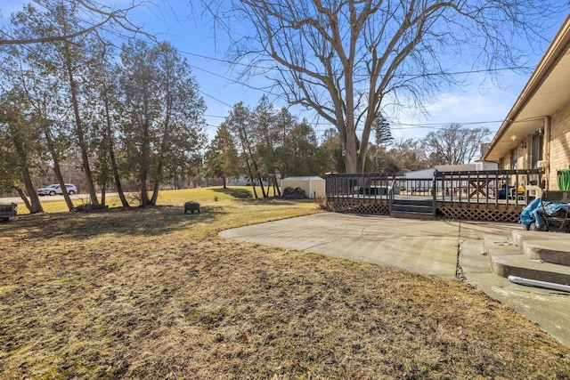 view of yard with a patio and a wooden deck