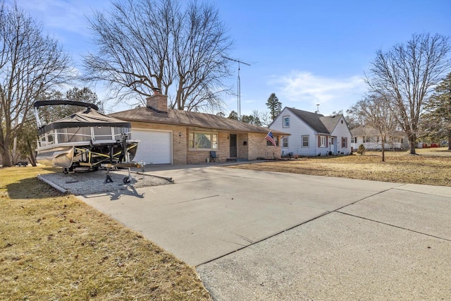 view of front of home featuring a chimney, an attached garage, concrete driveway, and brick siding