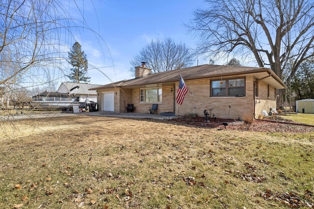 ranch-style house with a garage, brick siding, and a chimney