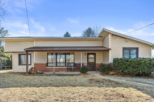 mid-century home with covered porch and brick siding