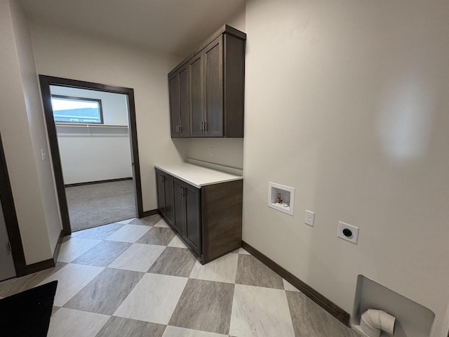 laundry area with cabinet space, electric dryer hookup, hookup for a washing machine, and baseboards