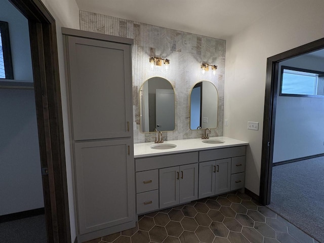 full bath featuring double vanity, tile patterned flooring, and a sink