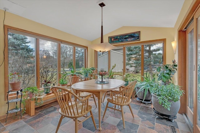 sunroom with plenty of natural light and vaulted ceiling