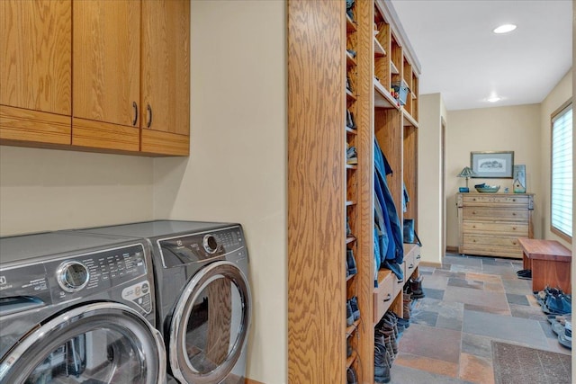 clothes washing area with recessed lighting, cabinet space, independent washer and dryer, and stone finish floor