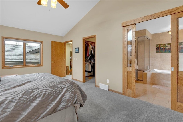 carpeted bedroom featuring baseboards, visible vents, high vaulted ceiling, a closet, and a walk in closet