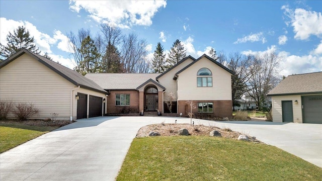 tri-level home featuring brick siding, driveway, a front lawn, and a garage