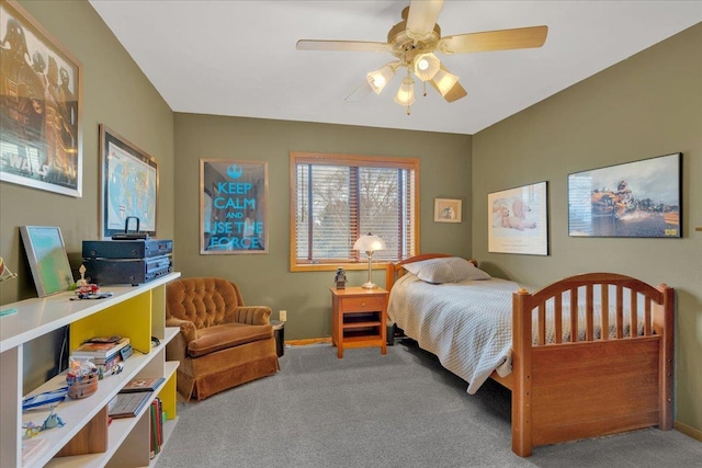 carpeted bedroom featuring baseboards and a ceiling fan