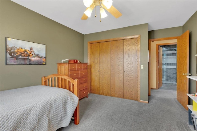 carpeted bedroom featuring a closet and ceiling fan