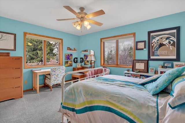 carpeted bedroom with a ceiling fan and baseboards