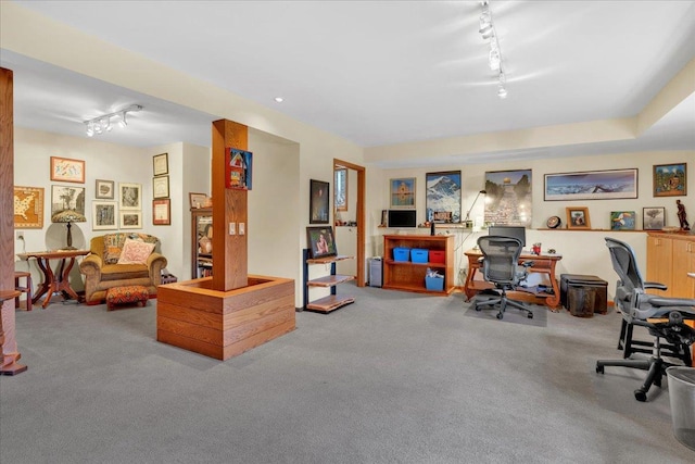 carpeted home office featuring rail lighting