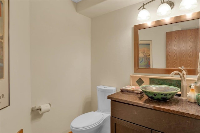 bathroom featuring toilet and vanity