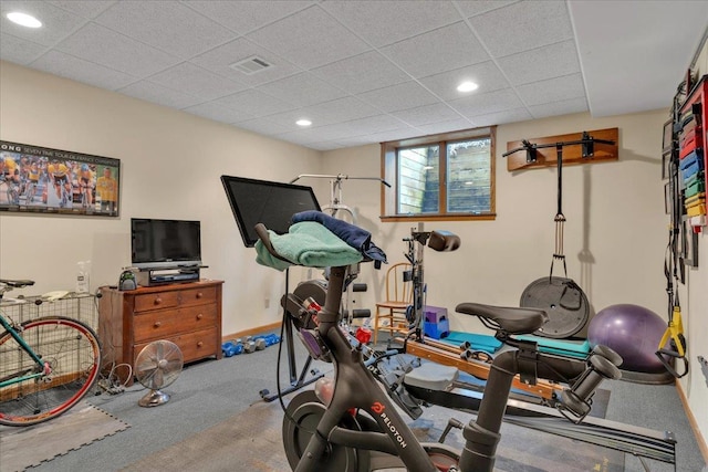 exercise room featuring baseboards, visible vents, recessed lighting, a paneled ceiling, and carpet flooring