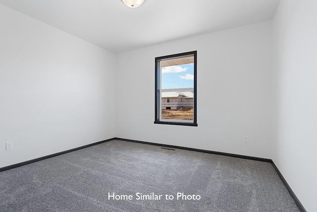 empty room with visible vents, baseboards, and carpet flooring